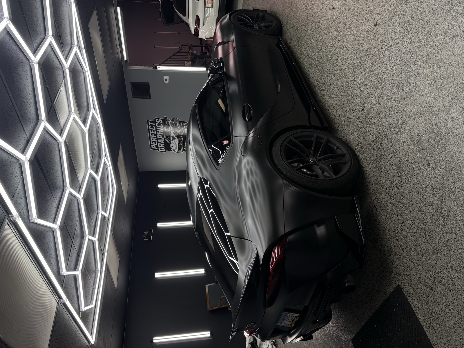 Satin black Toyota Supra with gloss black chrome-delete accents