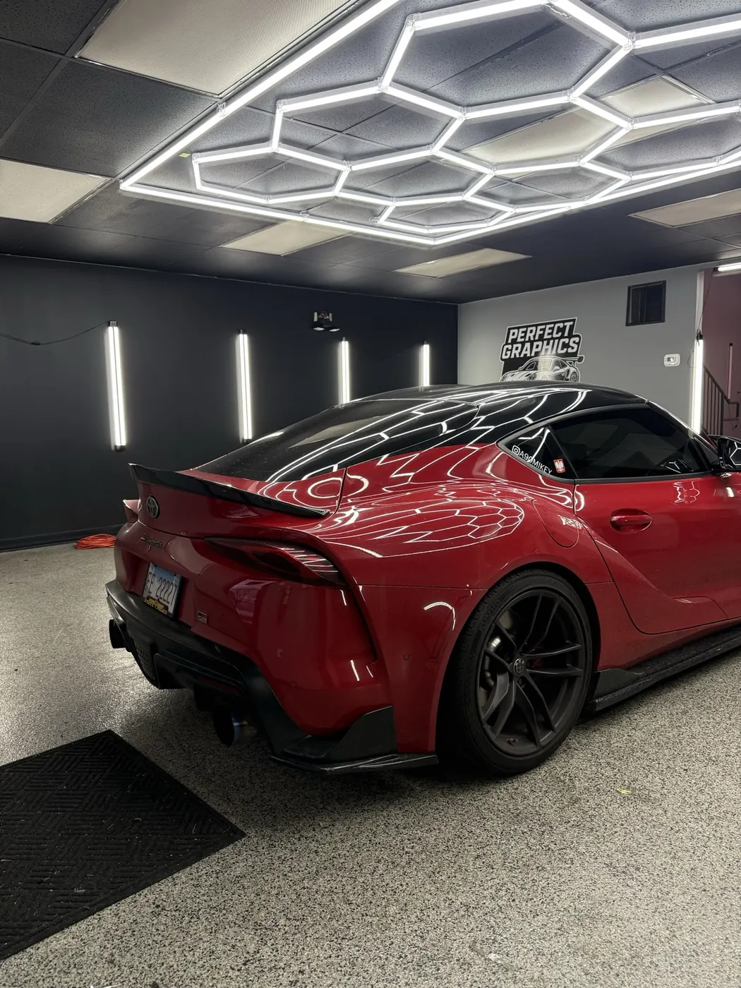 Candy red Toyota Supra rear profile in the Perfect Graphics studio