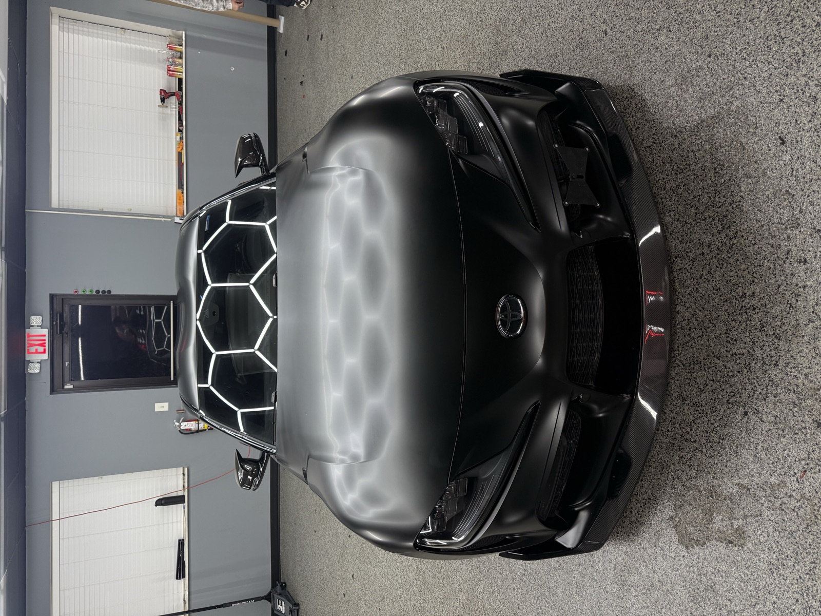 Satin black Toyota Supra front detail under the hex lights