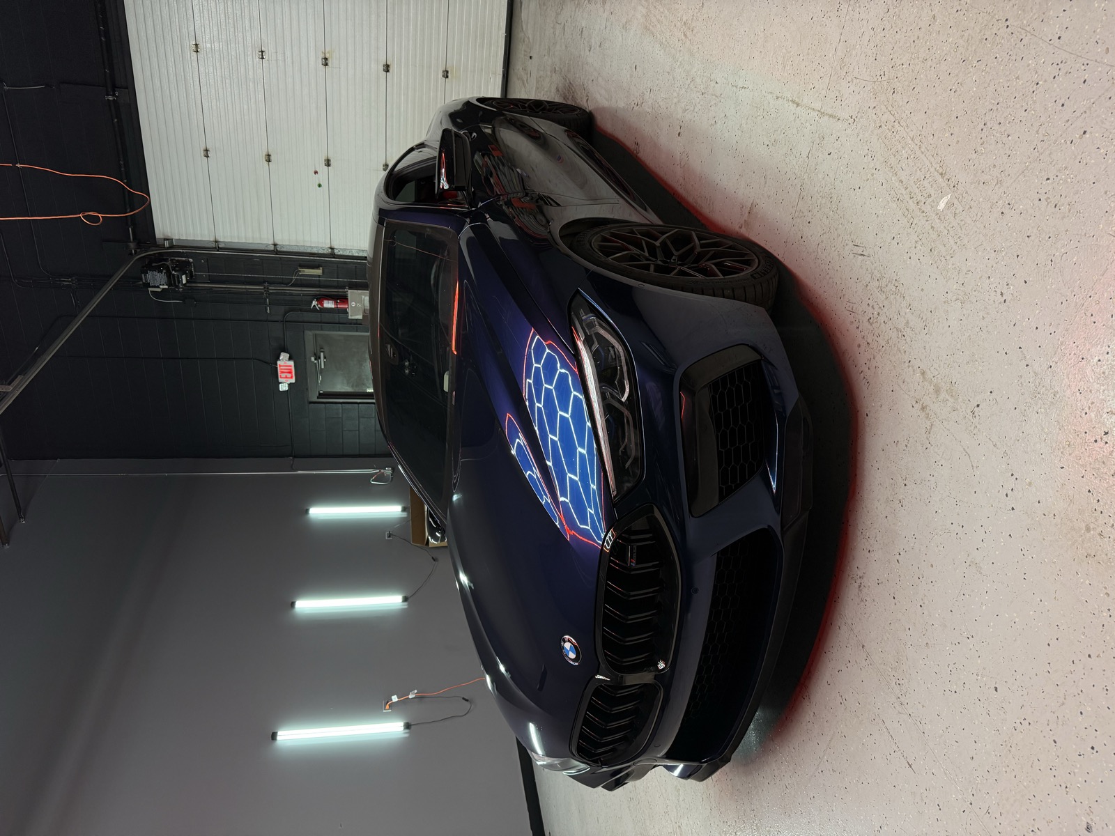 BMW M8 navy blue wrap — front three-quarter