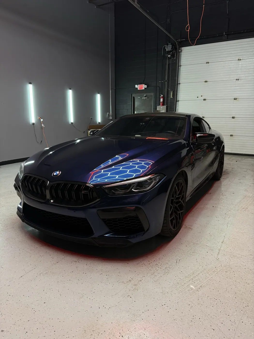 BMW M8 navy blue wrap, front three-quarter