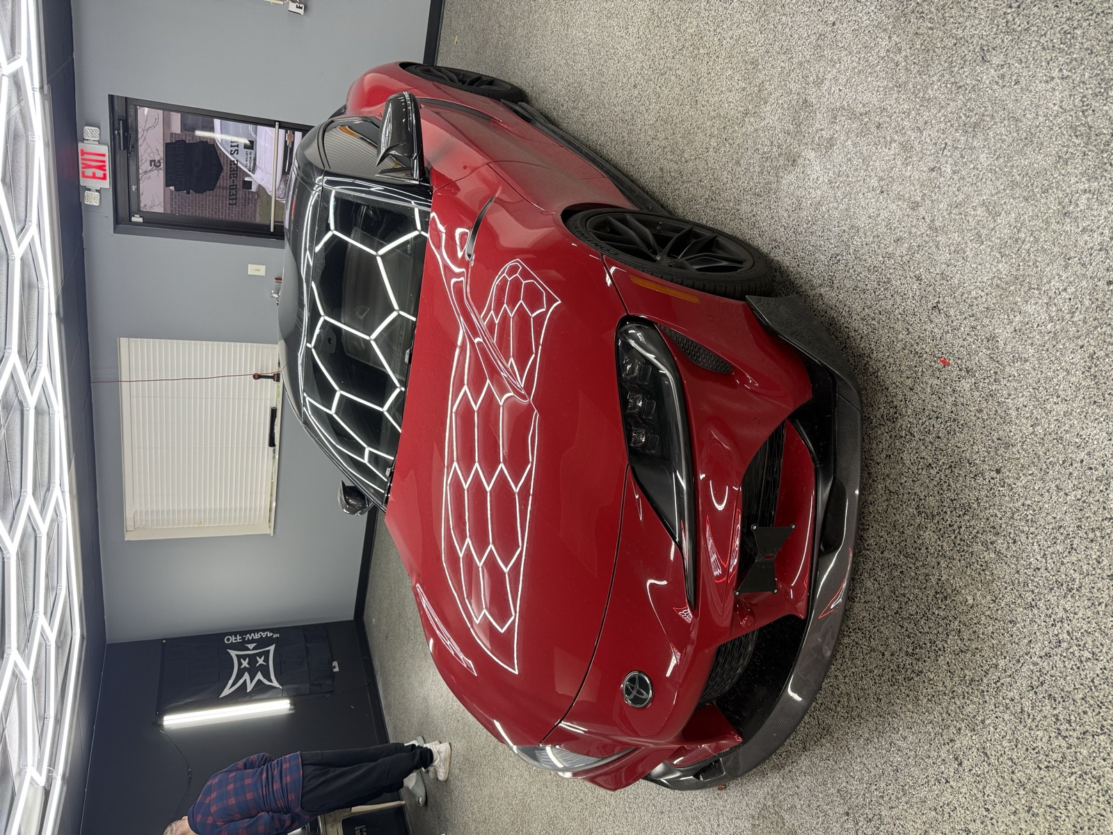 Candy red Toyota Supra with custom graphics and carbon accents