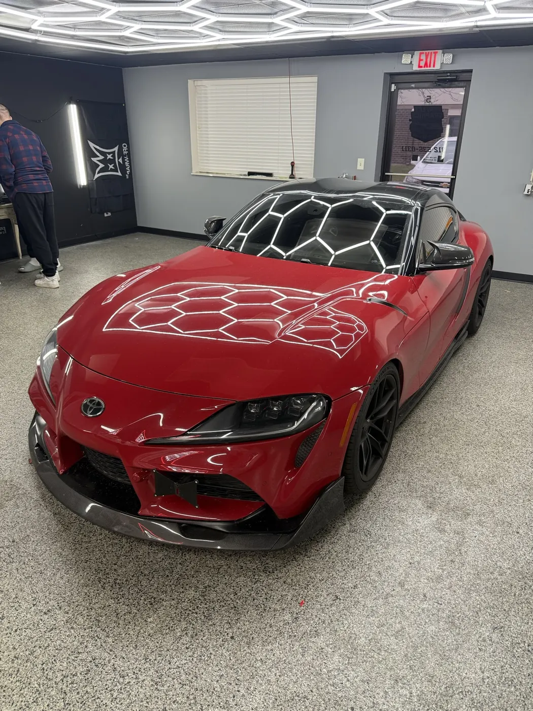 Candy red Toyota Supra with custom graphics and carbon accents