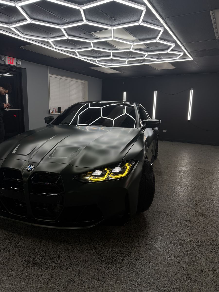 Front end and grille of a military green wrapped BMW M4