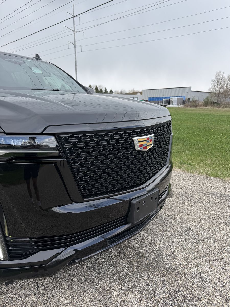 The same Cadillac Escalade after the chrome delete, the grille surround and trim finished in black