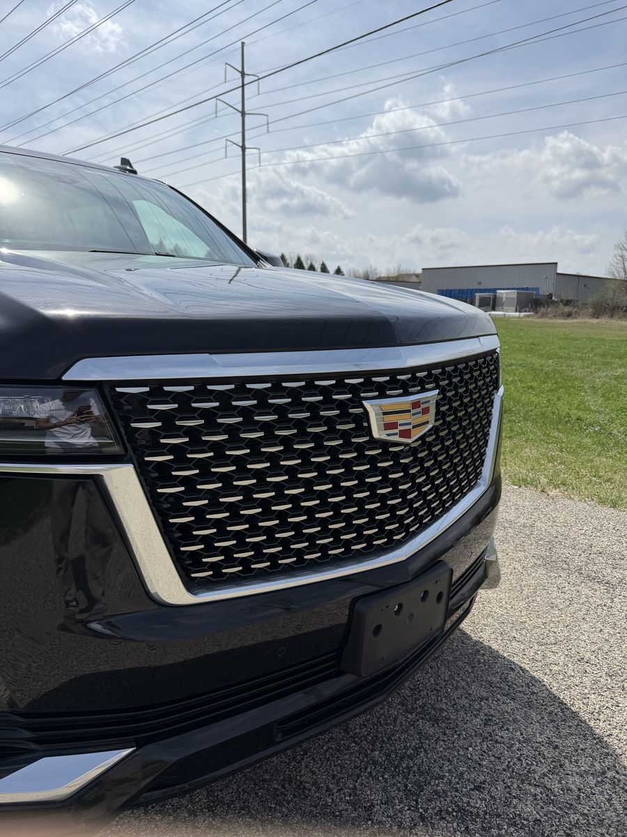 Cadillac Escalade front end before the chrome delete, with the factory bright chrome surround around the grille and headlight