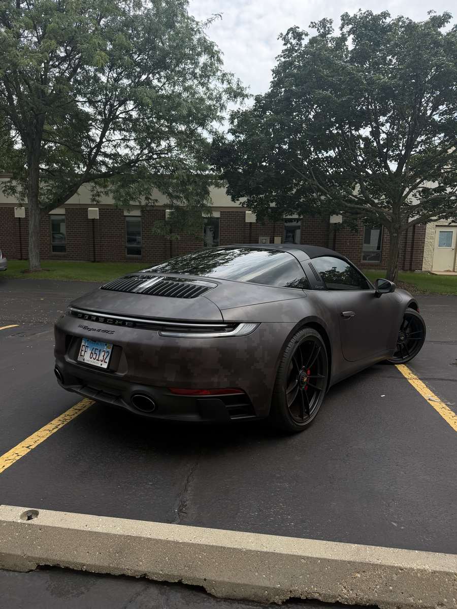 Rear three-quarter of the Porsche 911 Targa 4 GTS in the matte digital camo wrap