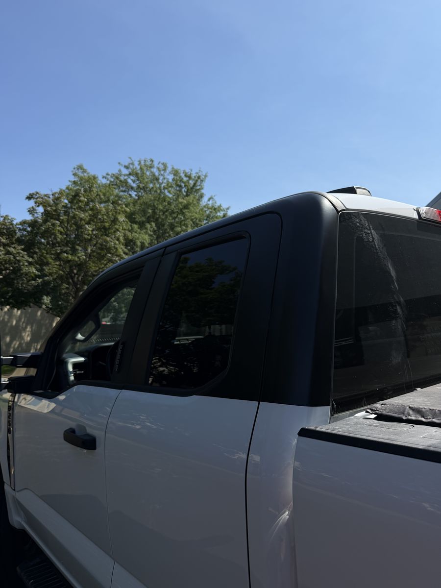 Tinted door and rear glass on a white pickup truck