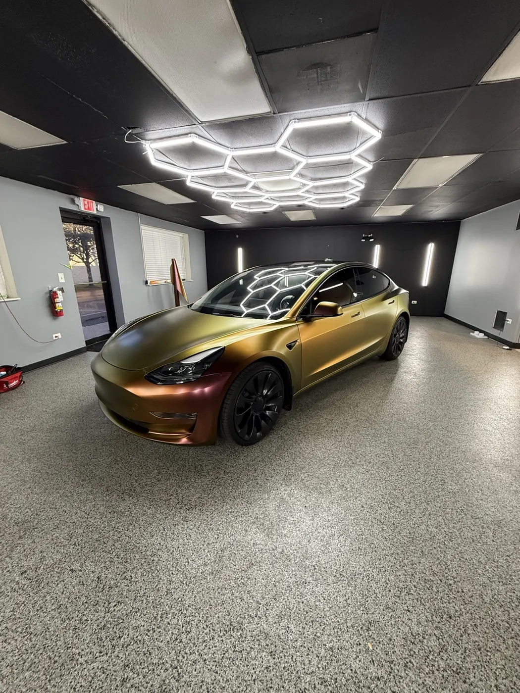 Gold color-shift car wrap on a Tesla Model 3 by Perfect Graphics in Cary, IL